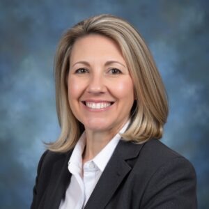 Karen Frizzell, Office Administrator at the Manatee Education Foundation, smiling in a professional headshot wearing a dark blazer.