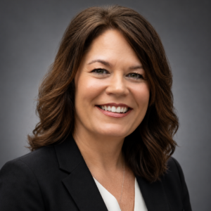 Kathy Price, Executive Director of the Manatee Education Foundation, smiling in a professional headshot wearing a black blazer.