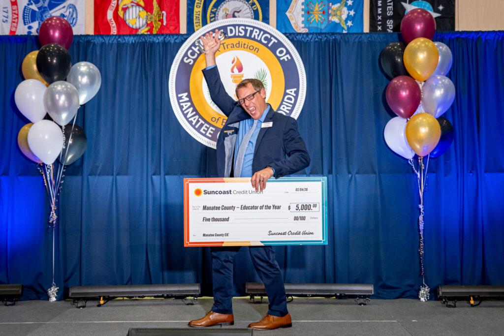 Cliff Dawson, 2026 Excellence in Education Award Educator of the Year winner celebrating on stage.